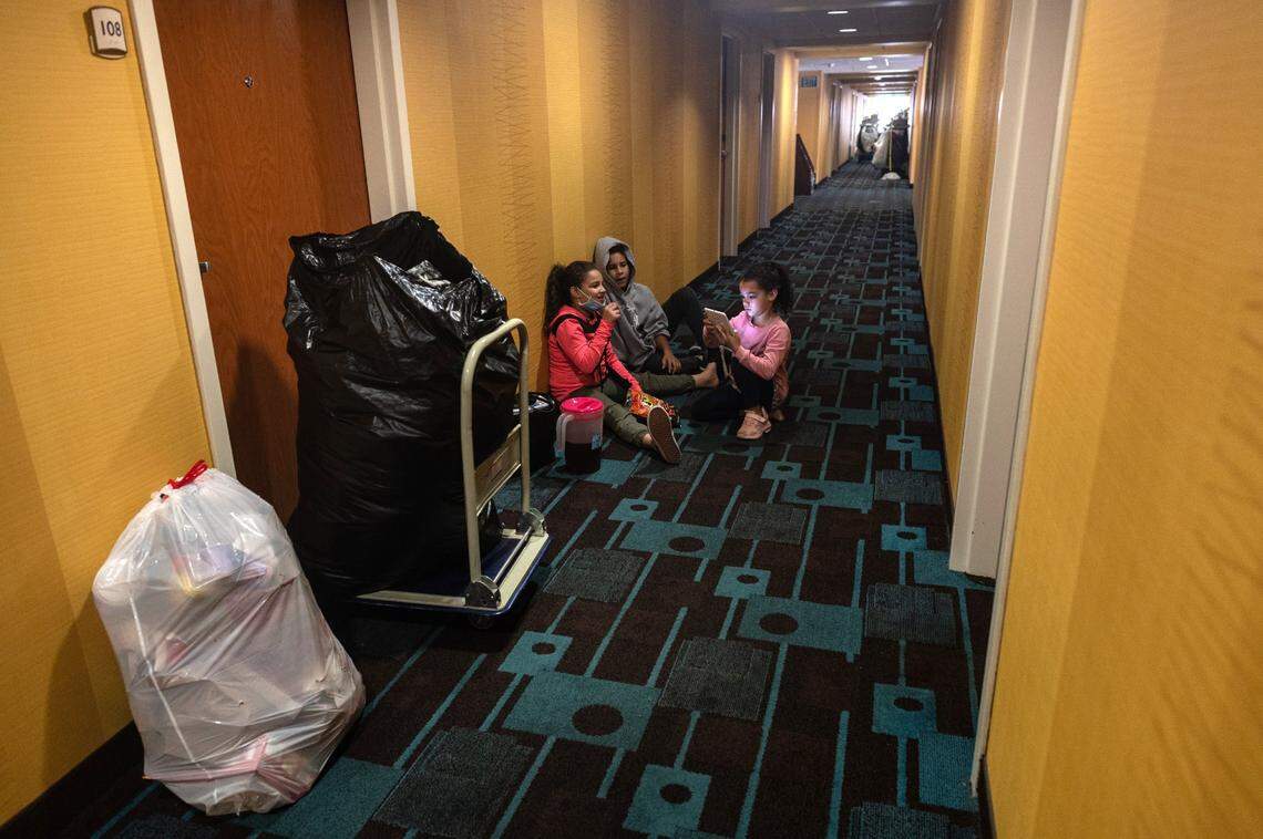 Aryanna Slain, 8, Tyree Franklin, 11, and Shyann Slain, 7, wait for their mom to finish cleaning out their room at the Fairfield Inn in January. Outside their dad Anthony Slain, 45, was packing the car with their belongs.
