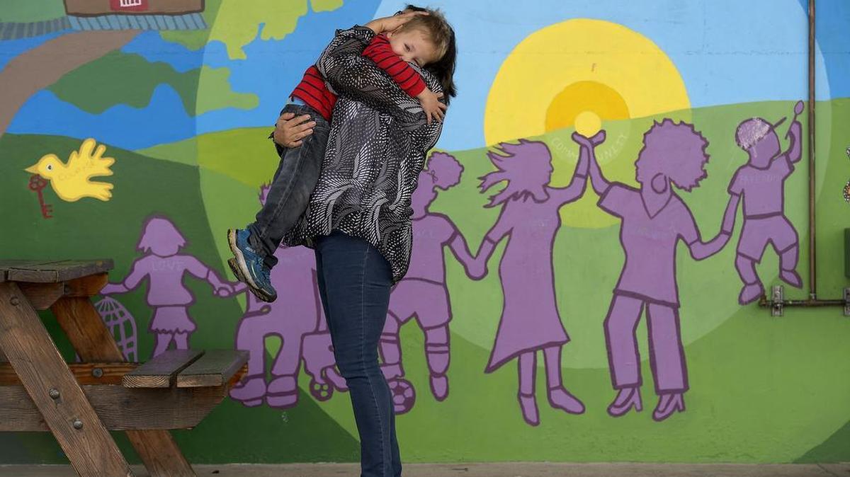 Vincent Dimarco 4, left, is hugged by his mother, Starr Smith, at Saint John’s Program for Real Change in Sacramento on Friday. Saint John’s, one of the Sacramento area’s largest and most successful programs serving homeless people, is in financial trouble as the county readjusts its funding priorities.