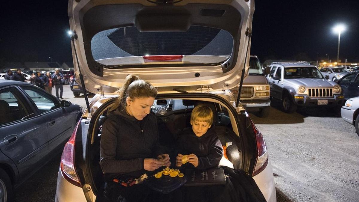 Robyn Vandervort and her son Ano, 9, evacuated Oroville and take shelter in their car at the Silver Dollar Fairgrounds because of a possible failure of the Oroville Dam on Sunday, February 12, 2017 in Chico, Calif. Schools will remain closed through at least Tuesday as residents remain under an evacuation order.
