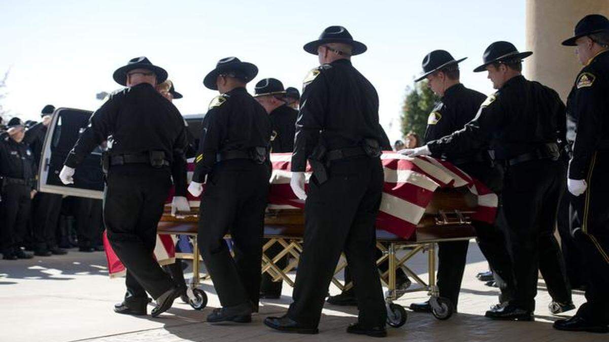 
The casket containing the body of Sacramento County Sheriff's Deputy Danny Oliver, one of two peace officers killed in an Oct. 24 rampage through Sacramento and Placer counties is wheeled to a waiting hearse by his fellow deputy's following a memorial service at Adventure Christian Church on Monday, Nov. 3, 2014 in Roseville, Calif.
