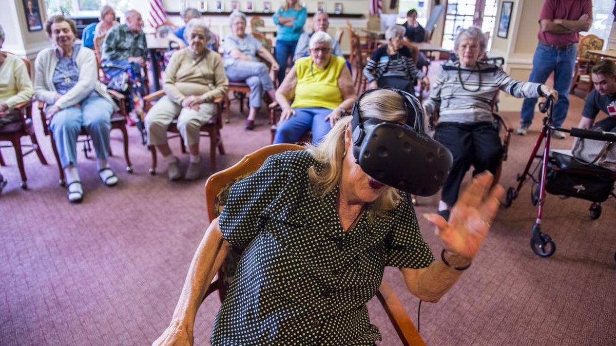 Marianne Shores, 76, “rides” a roller coaster through virtual reality goggles provided by the nonprofit Gamers Gift at Atria Carmichael Oaks on May 6, 2017. Shores said her first date was on a roller coaster and she loved them as child. Her virtual reality experience made her dizzy.