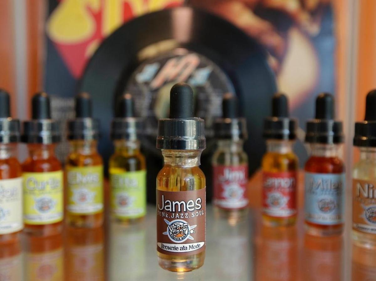 This file photo shows bottles of various flavors of vapor solution, known as “juice,” for use in e-cigarettes at a shop in Sacramento, Calif. Health officials warn that electronic cigarettes and other vaping devices are poisoning kids with nicotine.