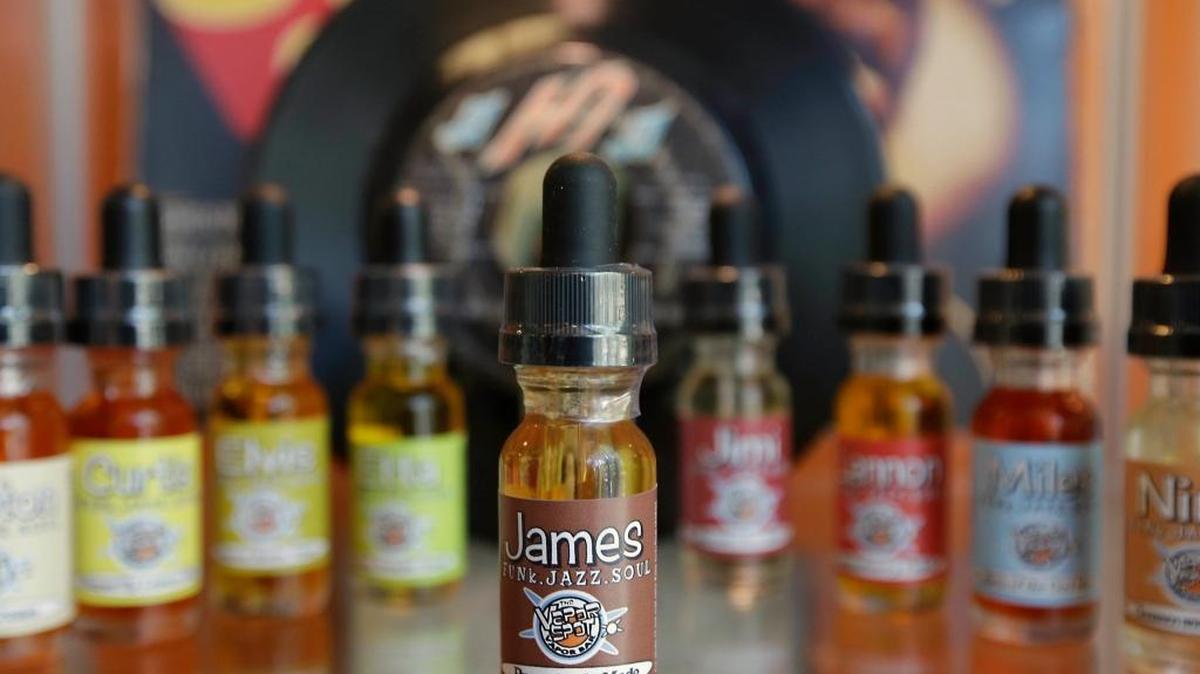 This file photo shows bottles of various flavors of vapor solution, known as “juice,” for use in e-cigarettes at a shop in Sacramento, Calif. Health officials warn that electronic cigarettes and other vaping devices are poisoning kids with nicotine.