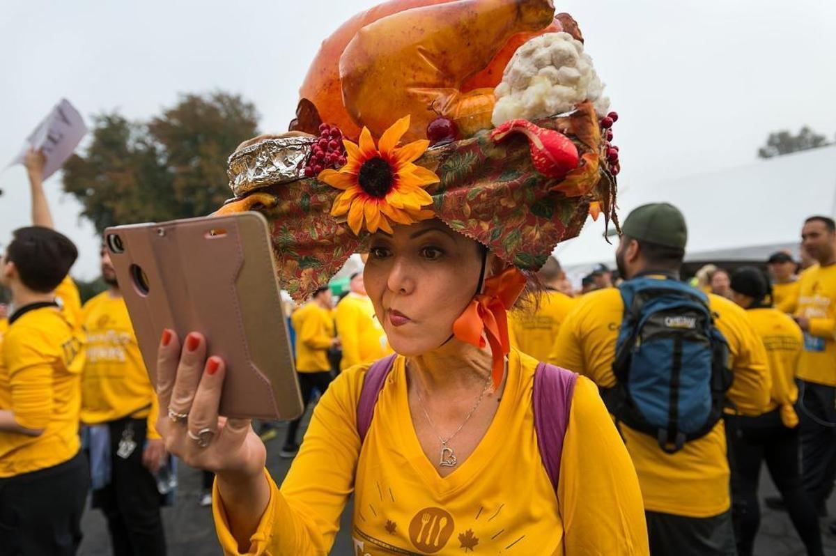Hillary Sunada, participating in her 10th race, adjusts her turkey headpiece during the Run to Feed the Hungry event in Sacramento on Thursday Nov. 23, 2017.