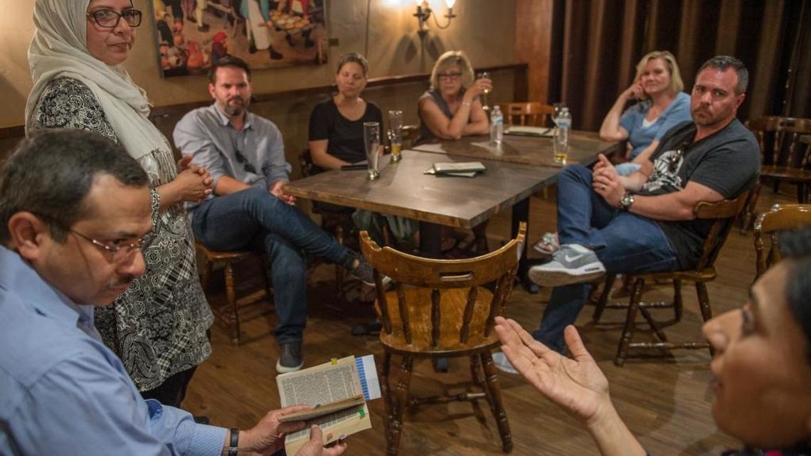 Moina Shaiq, left, listens as she leads a discussion at the #MeetAMuslim event along with Arshad Mirza, sitting with book, as Durriyo Syed, right, makes a point on Sunday in Roseville. The three Muslim Americans were part of a group of five that came to share a conversation at the Monk Center Brewery & Public House in Roseville.