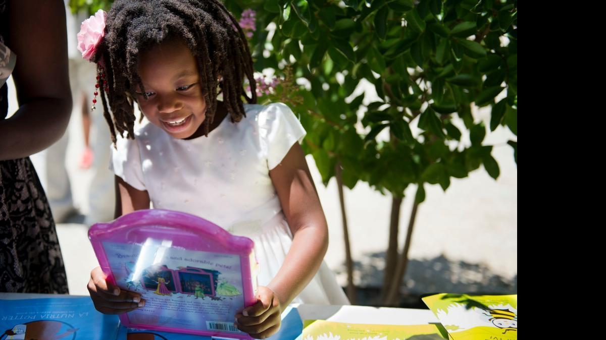 
Lolonyo Teasley, 7, picks out a free book at The Brickhouse art gallery on Sunday during the Sacramento Black Book Fair.
