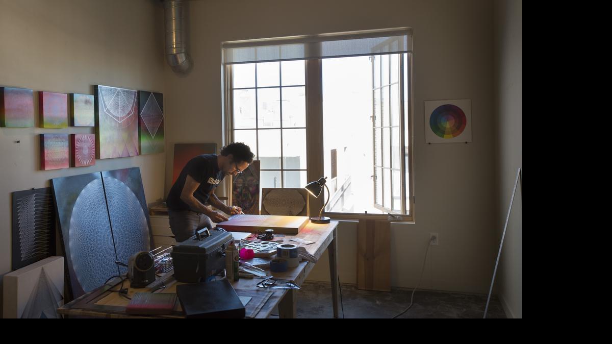 
Painter Jose Di Gregorio works on a mixed media on wood panel art piece at his loft in the new R Street lofts in Sacramento on May 26.
