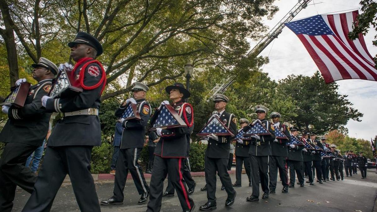 Firefighters carry flags to be presented to the loved ones of the fallen during the 2016 California Firefighters Memorial Ceremony at Capitol Park on Saturday, Oct. 15, 2016. Twentynine California service members who died in 2015 and recent years, most of them from job related cancer or heart attack, were honored and their names were added to the memorial wall.