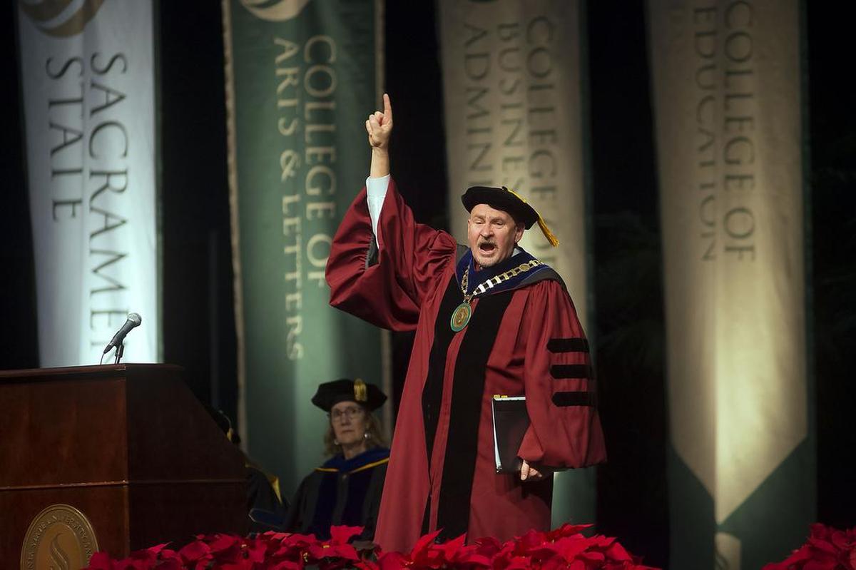 Sacramento State President Robert Nelsen addresses graduation candidates with a shout of “We are No. 1!” in December 2015, his first commencement ceremonies. Nelsen announced he will retire as president effective July 1, 2023.