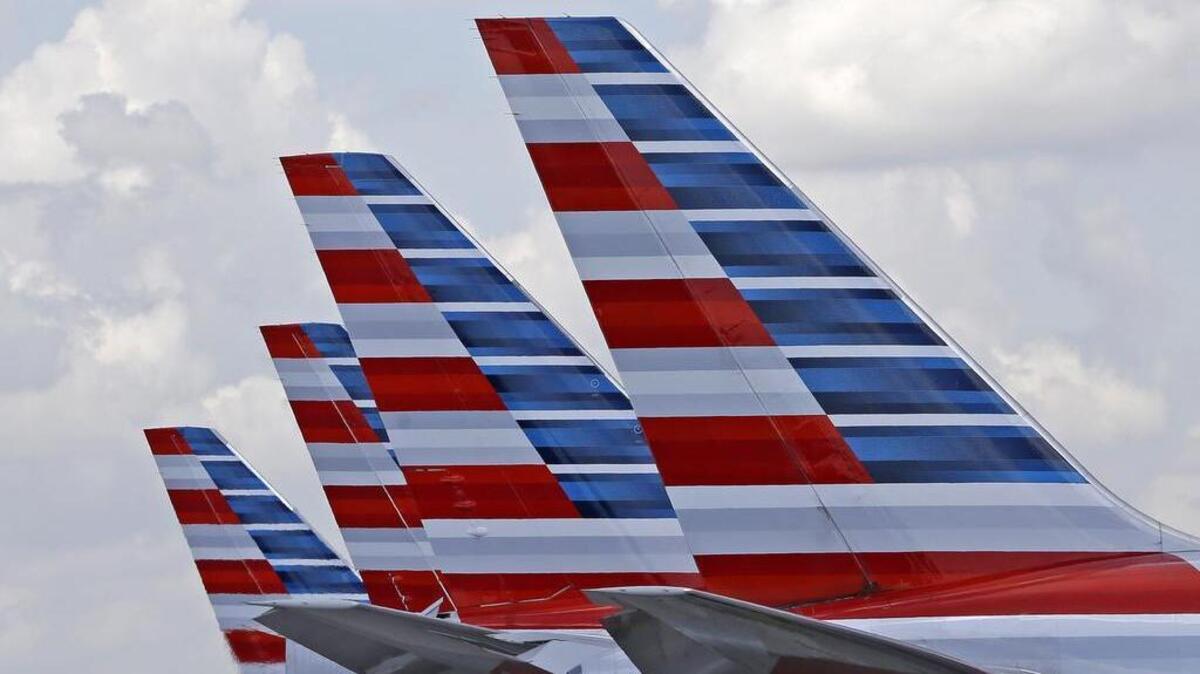 This photo July 17, 2015, photo shows the tails of four American Airlines passenger planes parked at Miami International Airport, in Miami.