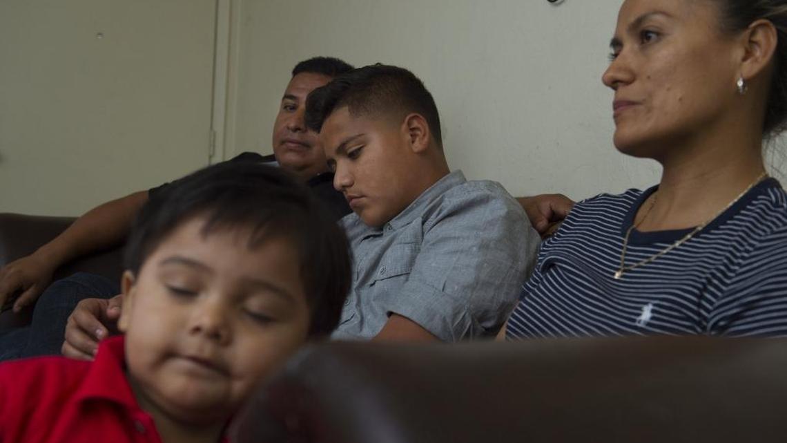 Felix Gonzalez, 13, previously uninsured, will be covered under new Medi-Cal expansion on May 15. He is seated with his parents Victor and Gabriela Gonzalez, and younger brother Victor, 1, in their apartment in Woodland on April 19, 2016.