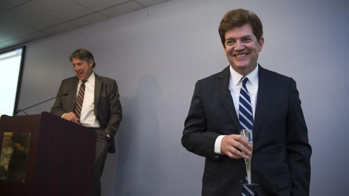 Sacramento Bee Editorial Page Editor Dan Morain offers a toast to editorial cartoonist Jack Ohman, right, as Ohman wins the 2016 Pulitzer Prize for editorial cartooning, Monday, April 18, 2016, in Sacramento, Calif.