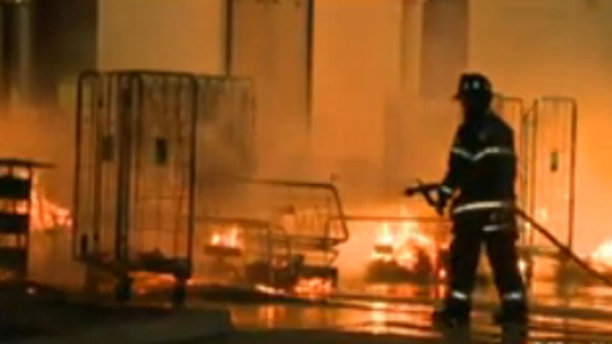 Fire crews hose the flames at Dollar General early Wednesday.
