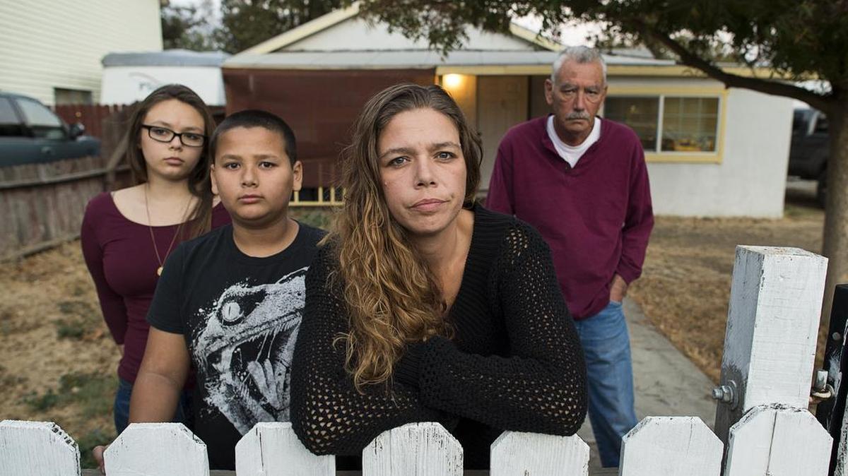 Rita Wages, 35, with her two children Joclyn Namauleg, 15, and Rayzon Ye, 10, and her dad, David Wages ,58, await the fate of her husband, Sareang Ye, on Thursday November 2, 2017 in Woodland, Calif. Her husband, Sareang Ye, was picked up by ICE last week during a nationwide sweep of Cambodians who are convicted felons. Ye served a sentence about 10 years ago and has been out of trouble since.