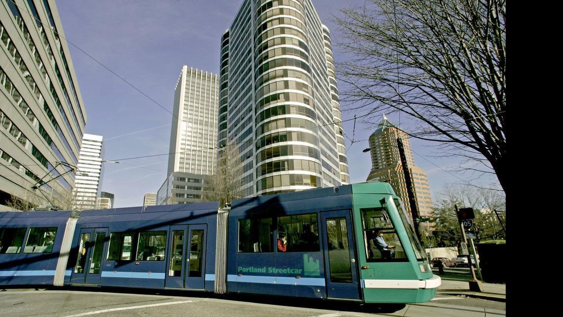 
Portland's streetcar runs through downtown on a loop of track that shares the street with cars and people. 
