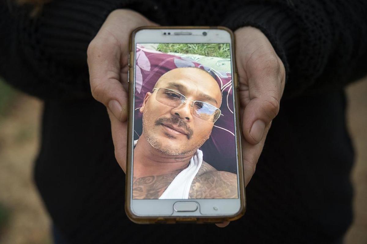 Rita Wages, 35, holds a phone photo of her husband, Sareang Ye, on Thursday. He was among Cambodians taken into custody who are convicted felons.
