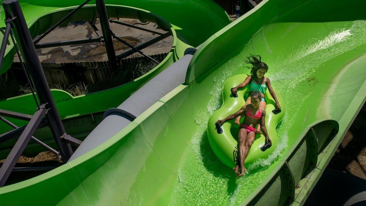 Kids ride down the Mako slide at Raging Waters water park at Cal Expo in July 2015.