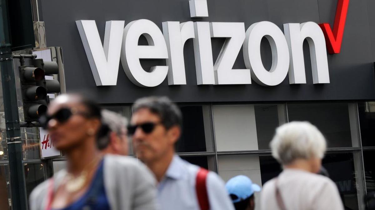 People walk past a Verizon store in Manhattan’s midtown area in New York.