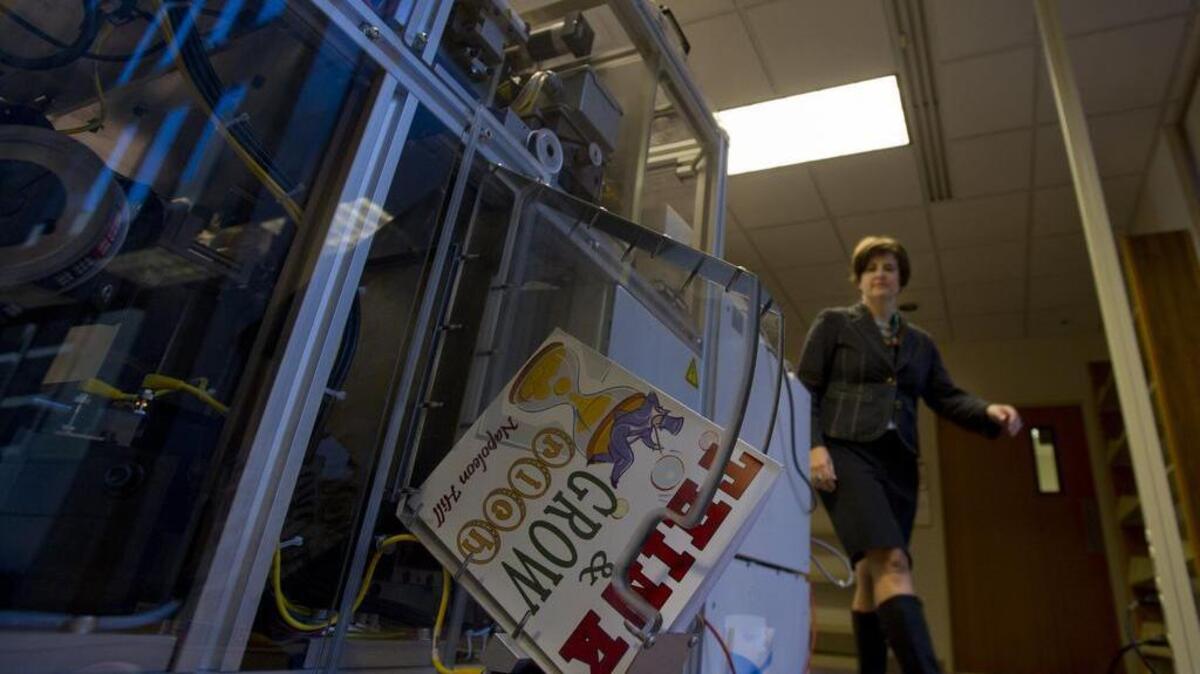 Sacramento Public Library Central Library Supervisor Manya Shorr goes around the Espresso Book machine to pick out a printed and fully bound book she programmed five minutes earlier.