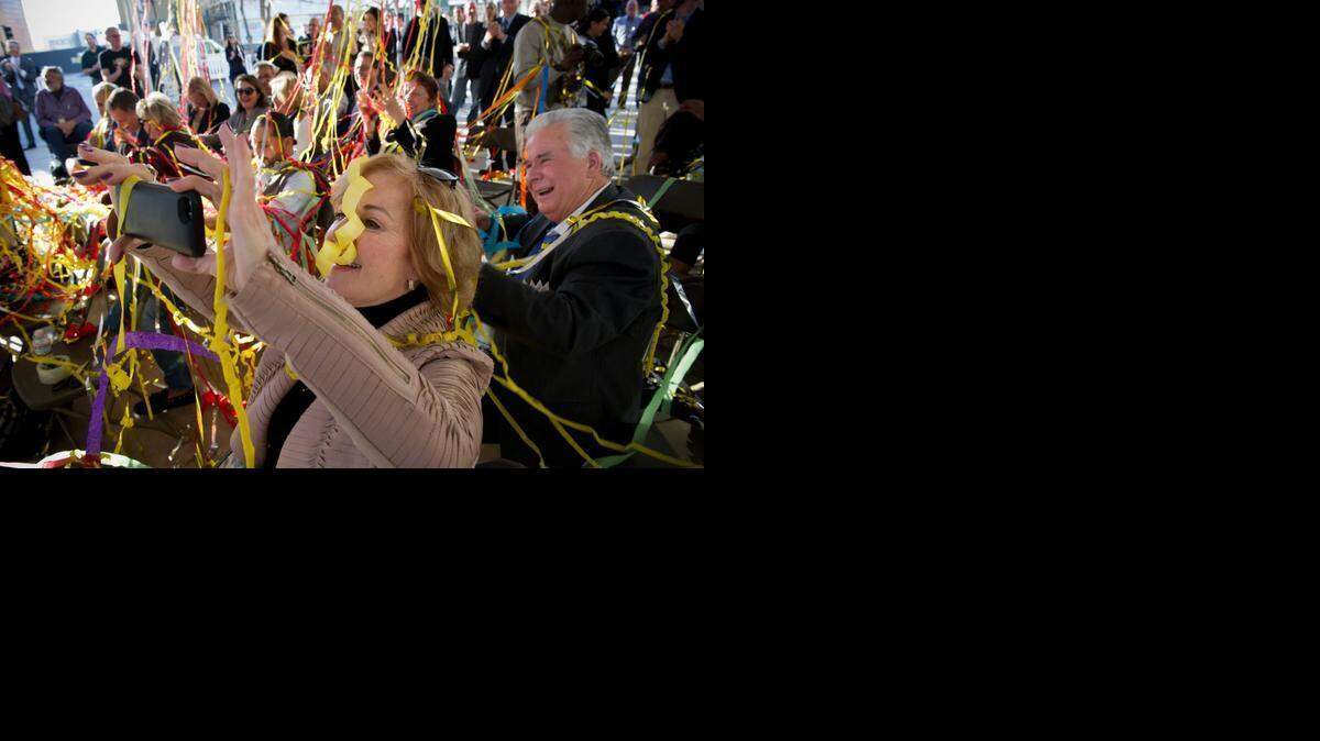 
Streamers fall on the crowd as Christine Kramer captures video on her cellphone during a celebration to officially kick off the start of construction on the 700 block of K Street project on Thursday at St. Rose of Lima Park.
