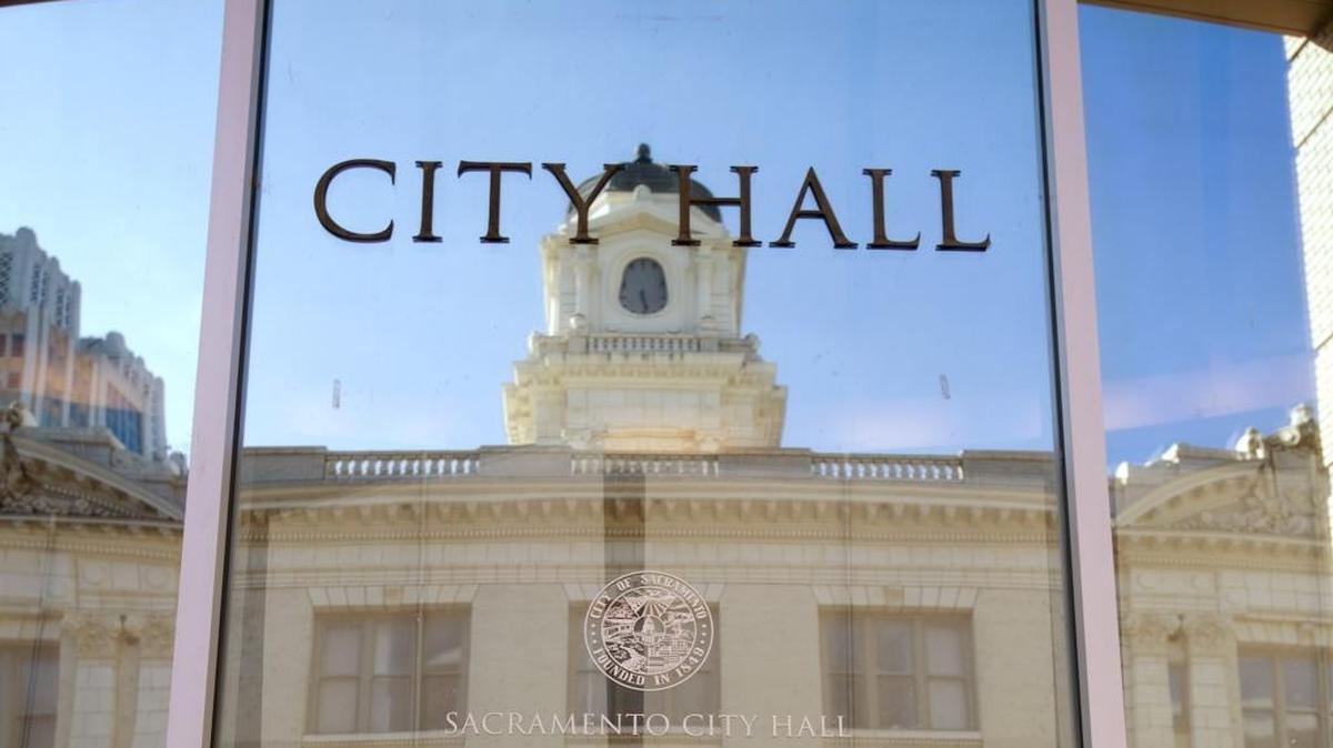 An image of old Sacramento City Hall reflects in the new annex building on April 29, 2014.