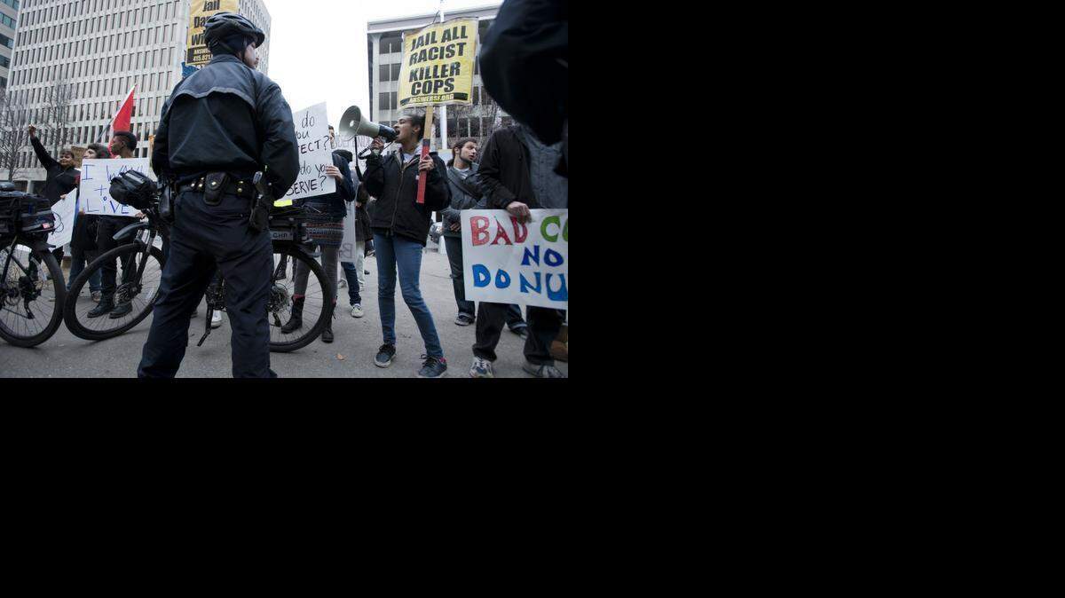 
Maile Hampton of the ANSWER Coalition (Act Now to Stop War and End Racism) and PSL (Party for Socialism and Liberation) chants into a megaphone and leads a protest against the Sacramento Rally to Support Law Officers at the state Capitol Jan. 18, 2015, in Sacramento.

