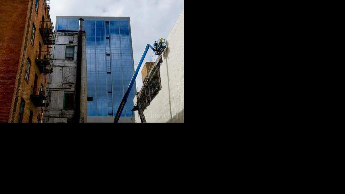 Workers remove the facade of the old Men's Macys on Thursday, September 18, 2014 in Sacramento Calif.