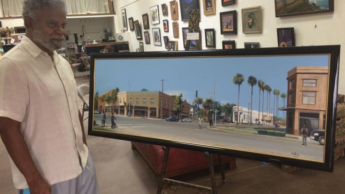 
Oak Park activist Robbin Ware shows off a painting he commissioned to celebrate redevelopment in Oak Park.

