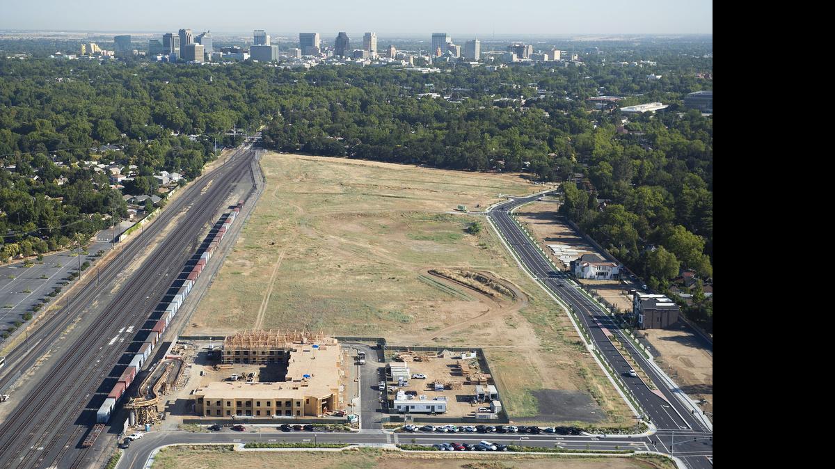 
Curtis Park Village, foreground, is seen with the skyline of downtown Sacramento in the background. After a lenghty debate late Thursday that stretched into Friday, the Sacramento Planning and Design Commission approved the addition of a 16-pump fuel station to the development, despite the objections of some residents.
