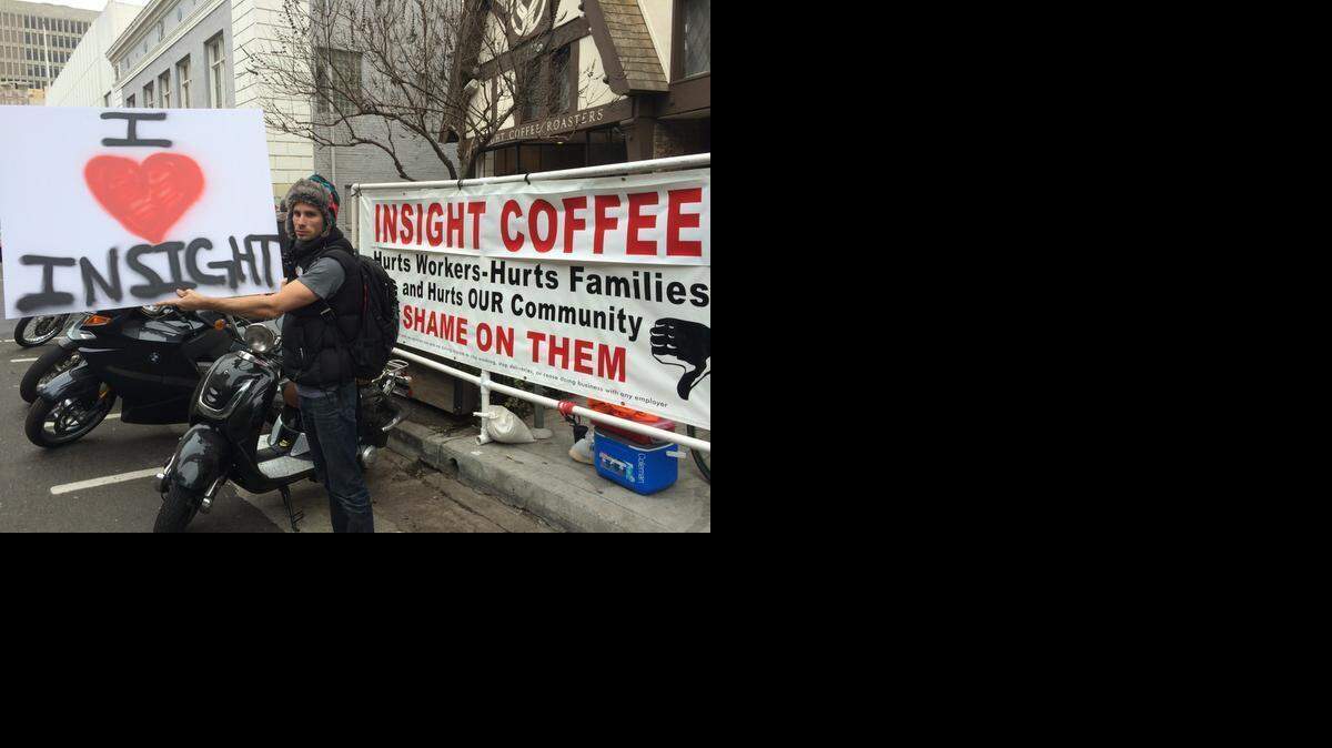 
Nicholas Wray, a Sacramento photographer, stages a counter-protest on Thursday to carpenters union demonstrators upset that a building that will house a new Insight Coffee is being constructed with non-union carpenters.
