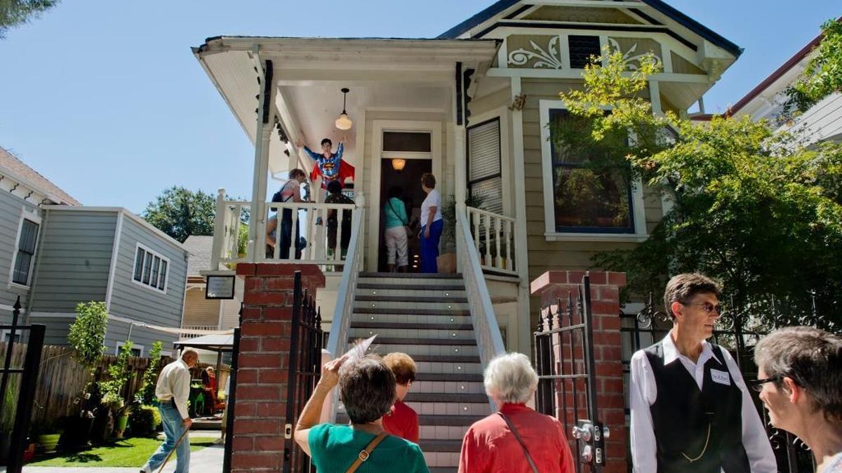 
A stream of people tour Dorothea Puente’s former home  on Sept. 15, 2013.  Bodies were found buried in what is now the yard at left.
