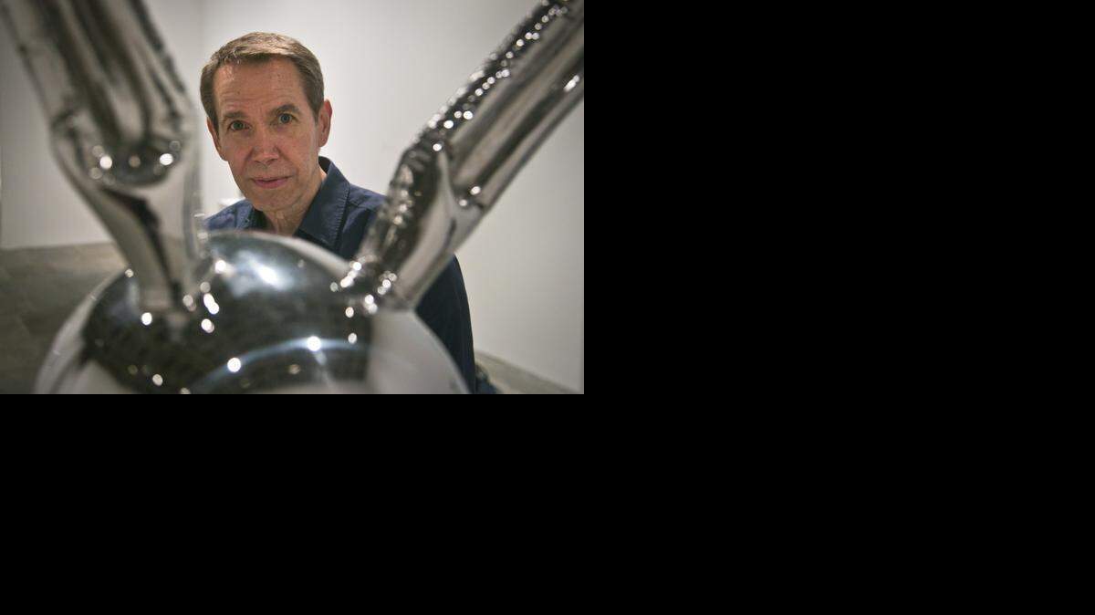 
Jeff Koons poses next to “Rabbit,” one of his oversized toy-like sculptures among works spanning a 30-year career being installed at the Whitney Museum of American Art on Monday, June 23, 2014, in New York. “Jeff Koons: A Retrospective,” marked the final exhibition at the Whitney’s uptown Manhattan location. (AP Photo/Bebeto Matthews)
