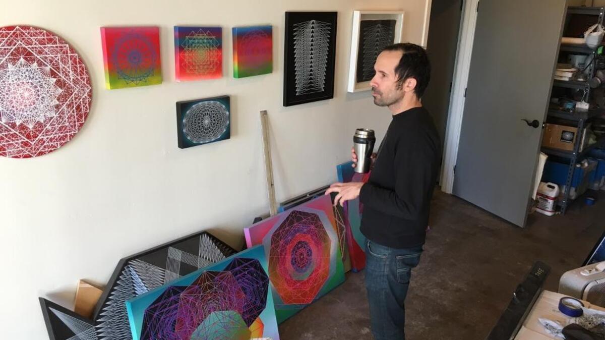 Artist Jose Di Gregorio looks at his work inside his studio at the Warehouse Artist Lofts in downtown Sacramento. Di Gregorio’s work will be shown at an exhibit during the prestigious Art Basel series in Miami in December.