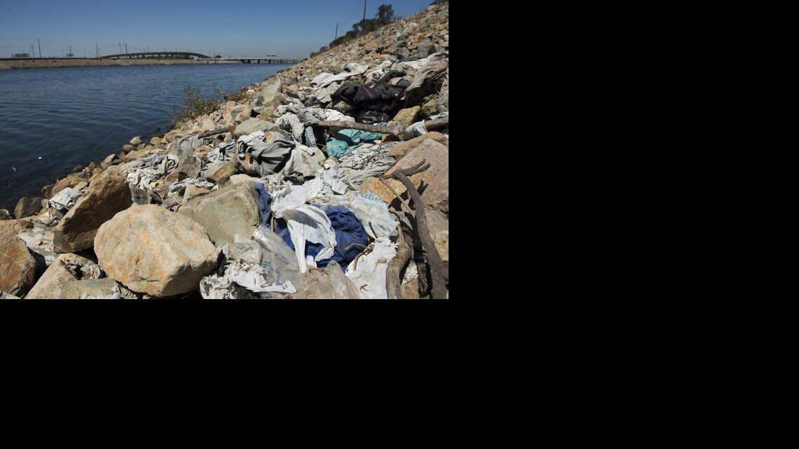 
A large pile of washed-up trash, including old plastic bags, sits alongside the Los Angeles River in Long Beach, Calif. On Tuesday, Sept. 30, 2014 Gov. Jerry Brown signed legislation on imposing the nation’s first statewide ban on single-use plastic bags. 
