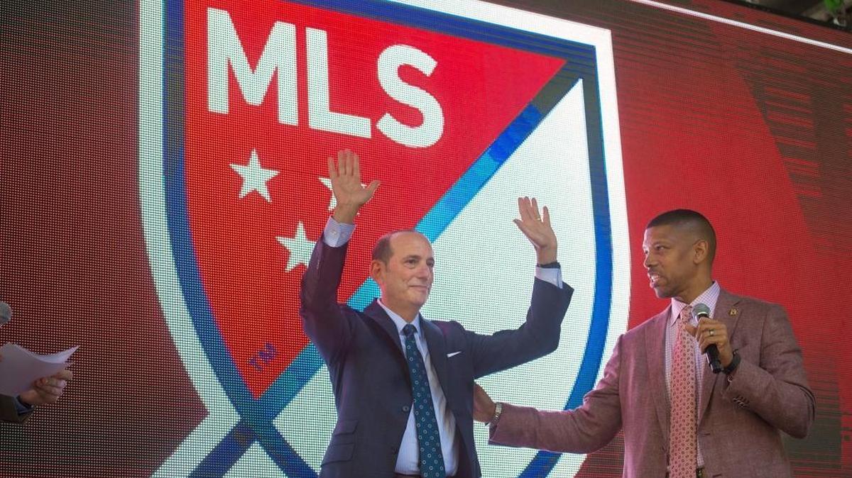 MLS commissioner Don Garber, with Mayor Kevin Johnson by his side, acknowledges cheering fans during a block party in downtown Sacramento on April 14, 2016. MLS may be ready to make good on Garber’s pledge to deliver an expansion franchise to Sacramento before Johnson leaves office.
