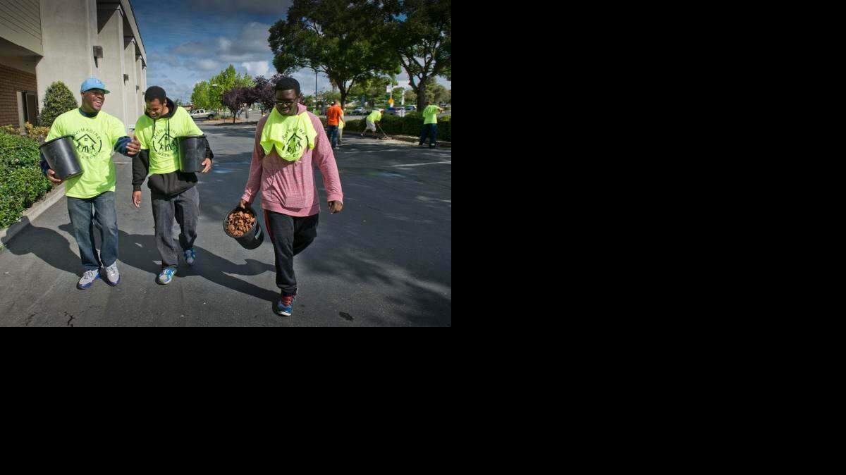 
DeAngelo Mack, coordinator of the Sacramento Violence Intervention Program, talks with DJ Williams, 21, and Zachary Haulcy, 15, both of Elk Grove as they worked on a variety of beautification projects on Mack Road and the area in April 2014.
