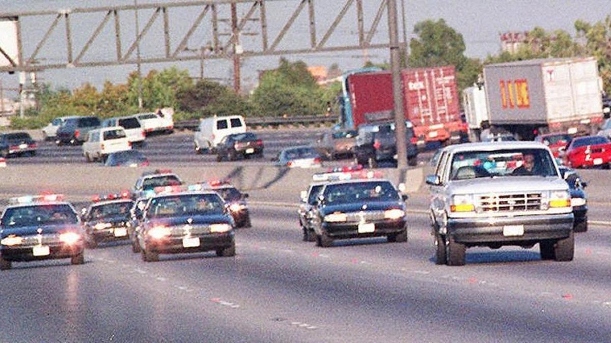 During the infamous “slow-speed chase,” police vehicles keep a close tail on a white Ford Bronco carrying O.J. Simpson during a northbound chase on the 405 San Diego freeway in Los Angeles County in 1994. Simpson was driven by Al Cowlings, a lifelong friend, to his California home.