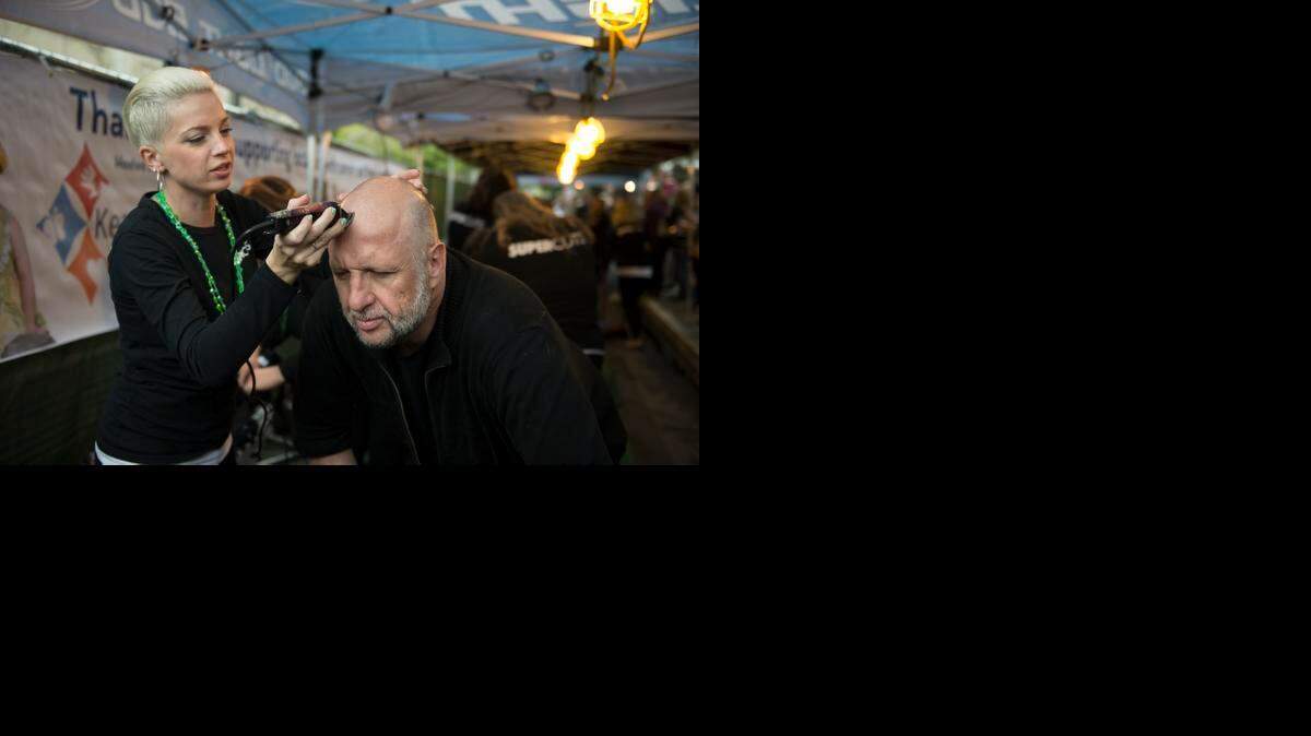 
Sacramento Bee columnist Marcos Breton gets a little touch up after getting his head shaved at the St. Baldrick's Foundation charity drive Monday.
