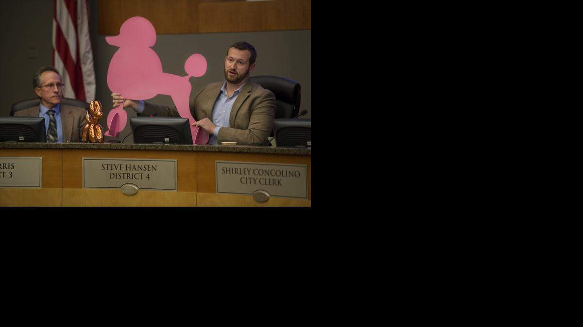 
Councilman Steve Hansen holds up a piece of local art he purchased next to the smaller Jeff Koons piece he purchased at the Crocker Art Museum during council discussion of the proposed purchase of the Jeff Koons art piece on Tuesday, March 10, 2015 at the Sacramento City Council meeting in Sacramento.
