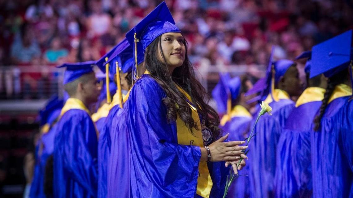 Nataly Romero, 18, of Fresno looks at the crowd at the Save Mart Center in Fresno as she attends her commencement ceremony on Wednesday.