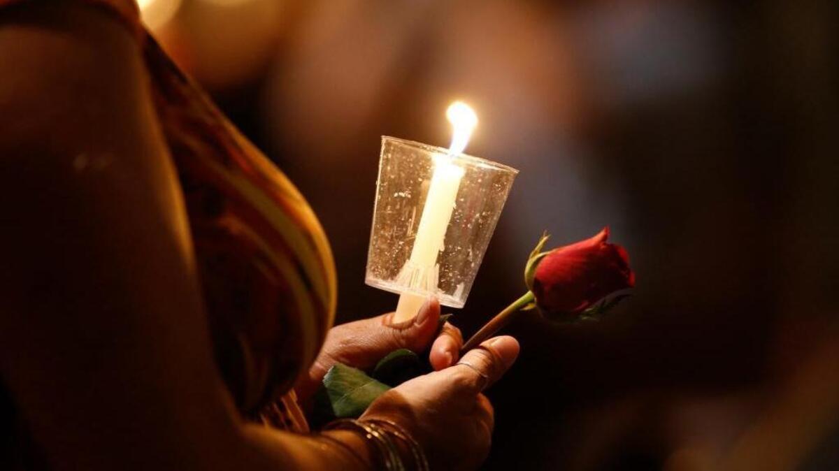 A worshipper attends a United To Heal Prayer Vigil on Friday, July 8, 2016, at Cathedral Guadalupe in Dallas in honor of the police officers who were slain Thursday. A peaceful protest in Dallas over the recent videotaped shootings of black men by police turned violent Thursday night as gunman Micah Johnson shot at officers, killing five and injuring seven, as well as two civilians.
