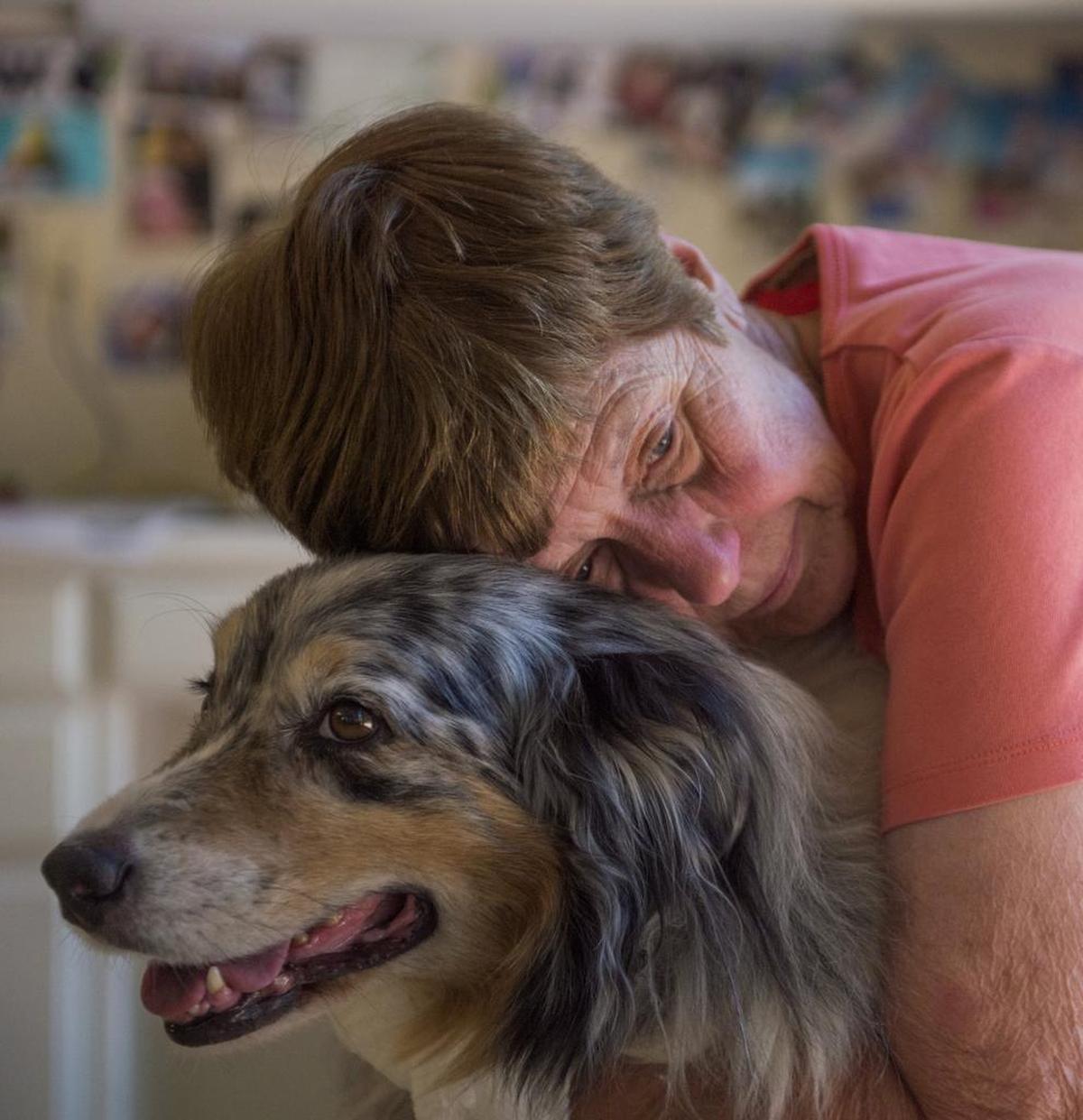 Geri Bigelow poses for a photo with Gus, her Australian Shepherd.