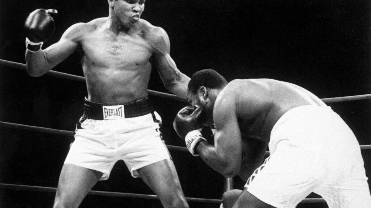 Muhammad Ali throws a punch at Joe Frazier, right, in the 12th round during their bout at Madison Square Garden in New York on Jan. 28, 1974. Ali, the magnificent heavyweight champion whose fast fists and irrepressible personality transcended sports and captivated the world, has died according to a statement released by his family Friday, June 3, 2016. He was 74.