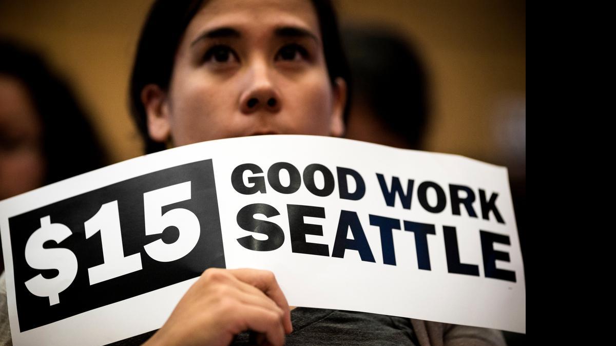 
Hoisting signs, supporters showed support for the passage of increasing the minimum wage in the city to $15 for Seattle employers on Monday, June 2, 2014, at City Hall in Seattle. Phased in over the next seven years, Seattle will have the highest minimum wage in America. Sacramento also is entering the minimum-wage discussion.
