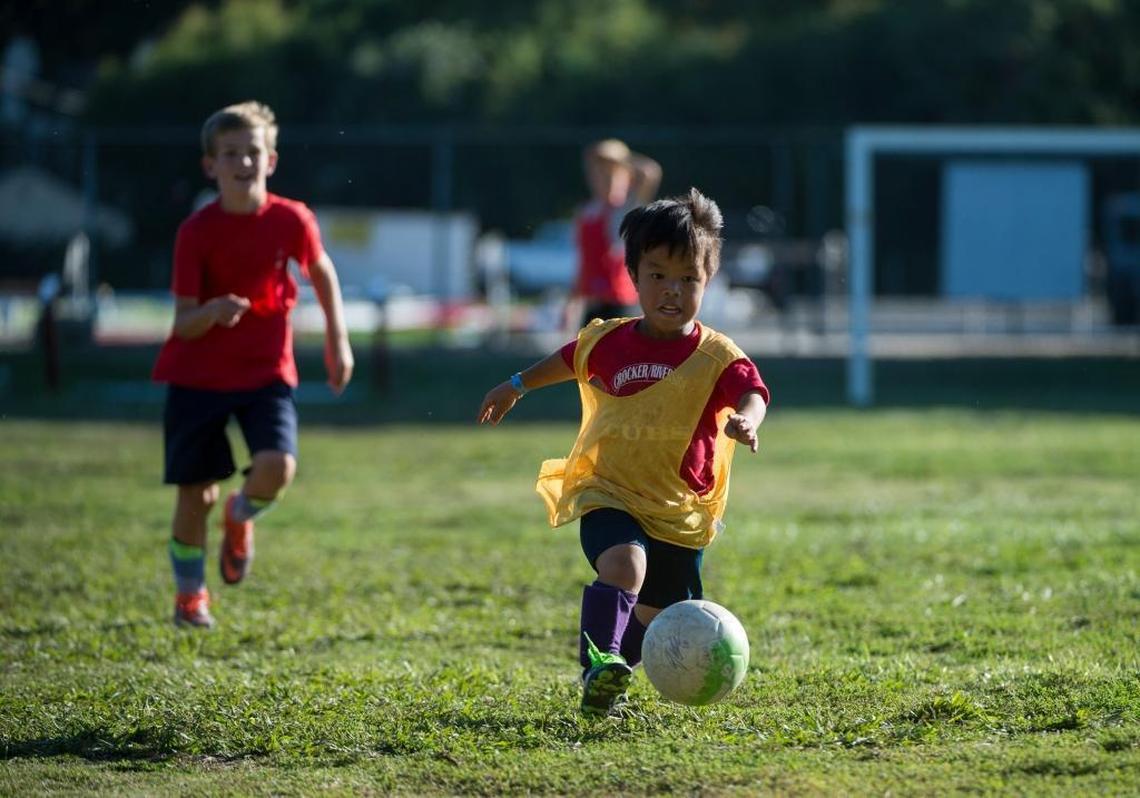 Hai Okenfuss, 10, considered by his coaches as the best ball handler on the soccer team, sprints down the field during practice at Cal Middle School.