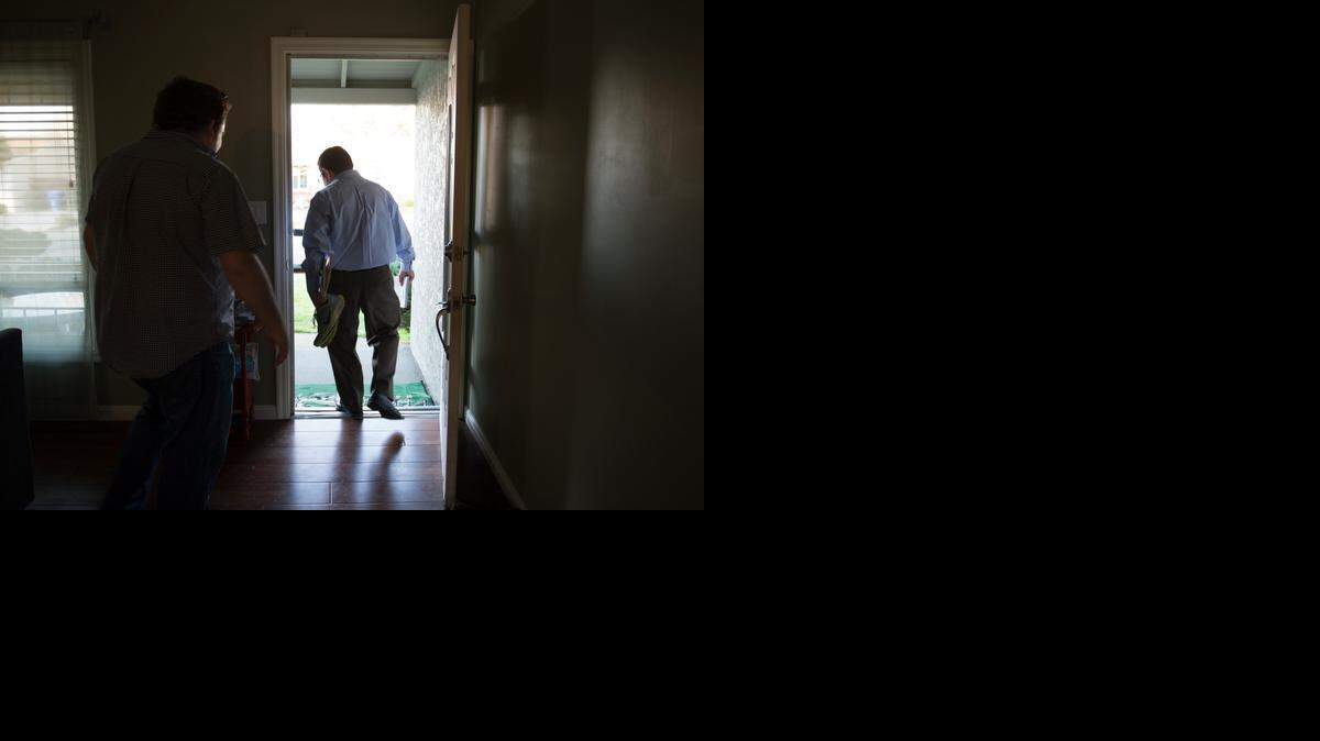 
Sacramento City Council candidate Eric Guerra, 36, leaves his home in Tahoe Park with jogging shoes in one hand and a map of his district in the other before going door to door to introduce himself to his constituents. Guerra, a farmworker’s child, is running in an April 7 special election to fill the seat vacated by Kevin McCarty.
