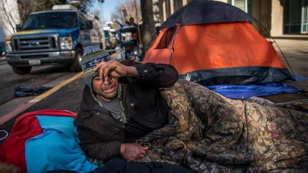 Ivan Dixon is one of the homeless protesters outside City Hall. They have accused police of “criminalizing” camping. City policymakers say it’s a public health issue.