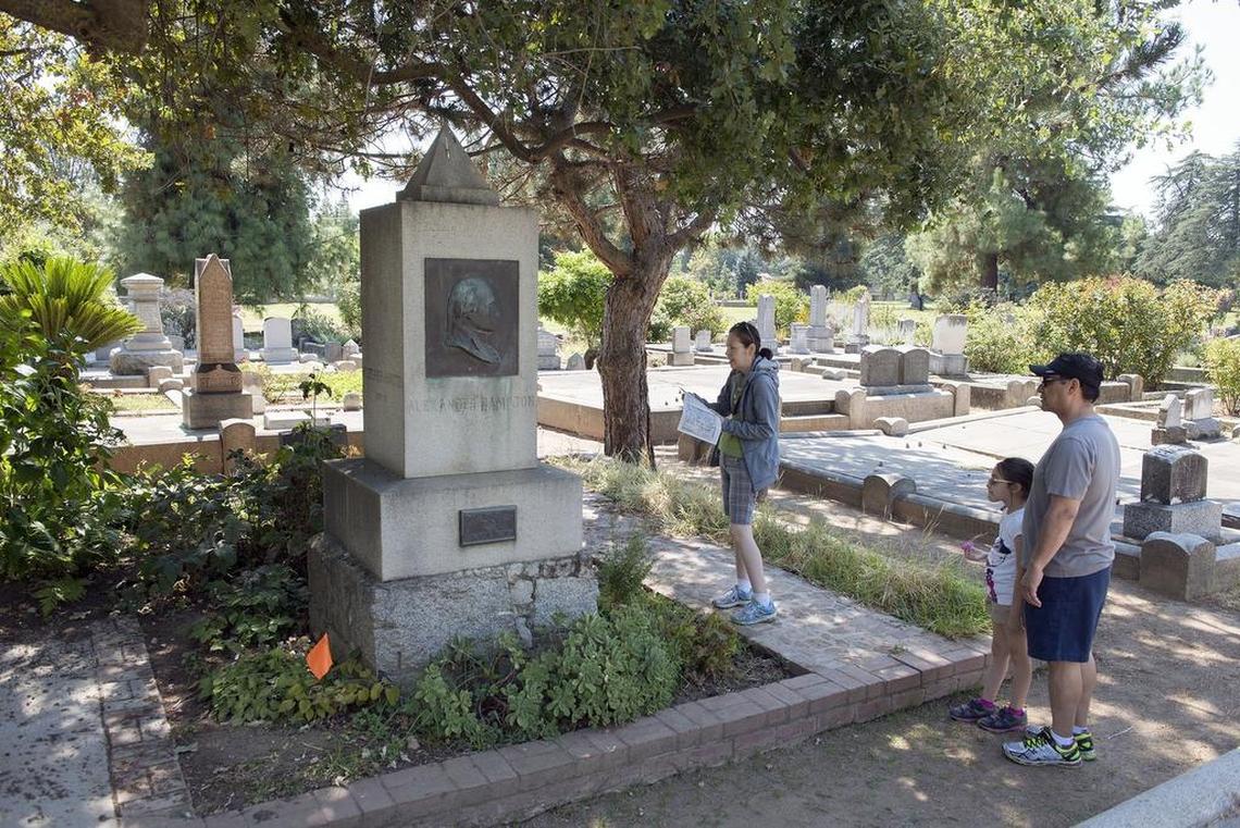 The Melendrez family from West Covina – Erin, 8, with her parents Carmen and Martin – look at the grave of William Stephen Hamilton at the Sacramento Historic City Cemetery in 2016. Hamilton is the son of America’s first treasury secretary, the subject of the hit musical “Hamilton.”