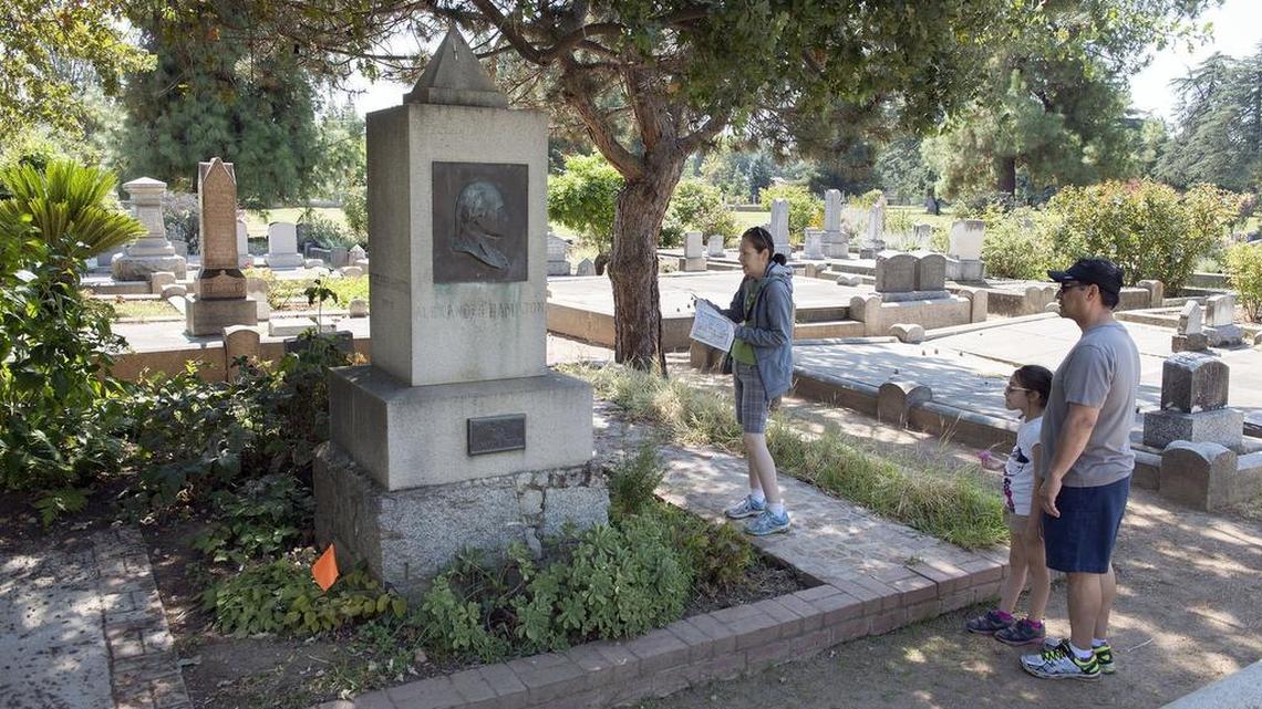 The Melendrez family from West Covina – Erin, 8, with her parents Carmen and Martin – look at the grave of William Stephen Hamilton at the Sacramento Historic City Cemetery on Aug. 16, 2016. Hamilton is the son of America’s first treasury secretary, the subject of the hit musical “Hamilton.”
