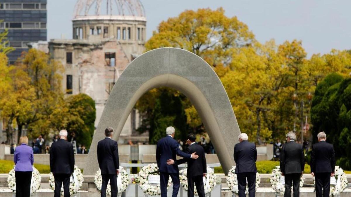 U.S. Secretary of State John Kerry, fourth from left, puts his arm around Japanese Foreign Minister Fumio Kishida after they and fellow G7 foreign ministers laid wreaths at the cenotaph at Hiroshima Peace Memorial Park in April. President Barack Obama will travel to Hiroshima this month in the first visit by a sitting American president to the site where the U.S. dropped an atomic bomb.